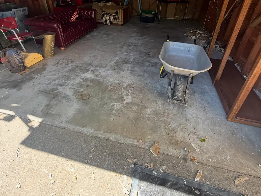 Garage before: cracked, stained bare concrete