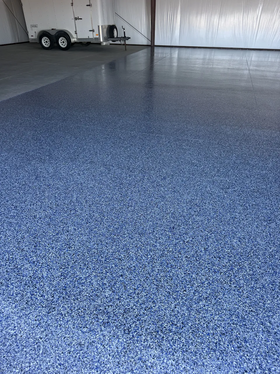 Finished shop floor with a trailer parked inside