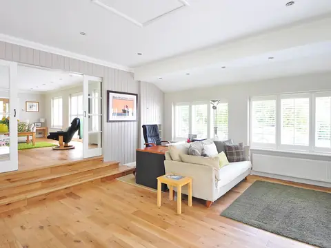 Light oak hardwood floor in a bright living room (stock photo)